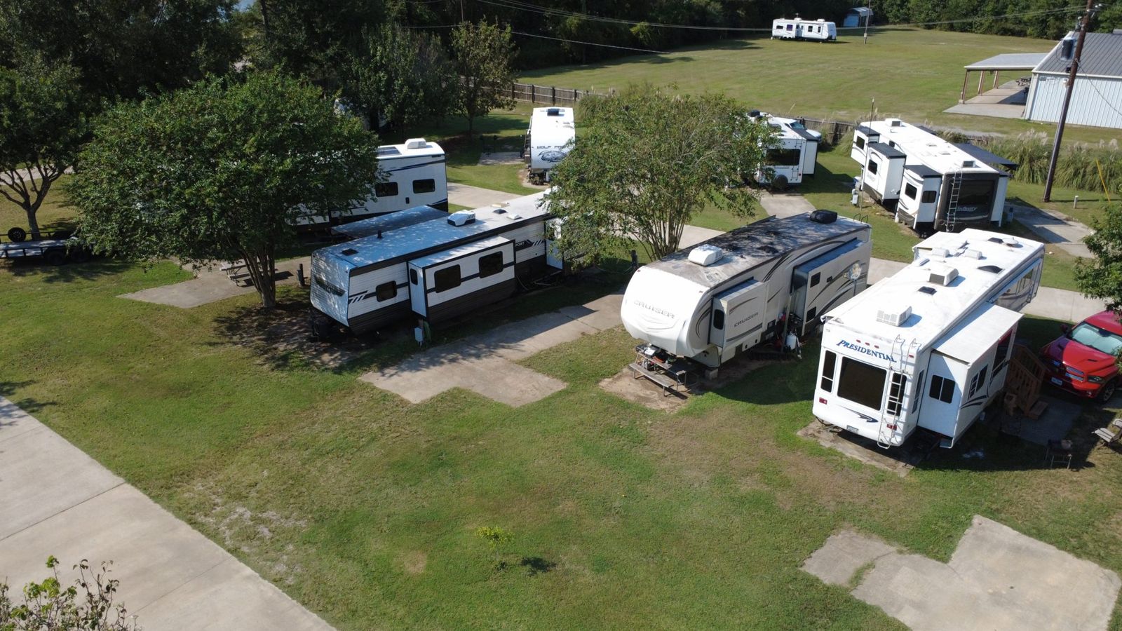 Fifth-wheel RVs parked on concrete pads at Red Cloud RV Park