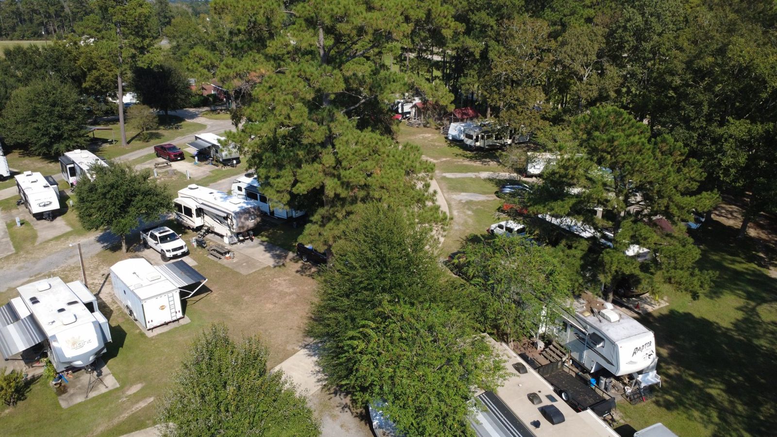 Aerial view of shaded RV sites under the trees at Red Cloud RV Park