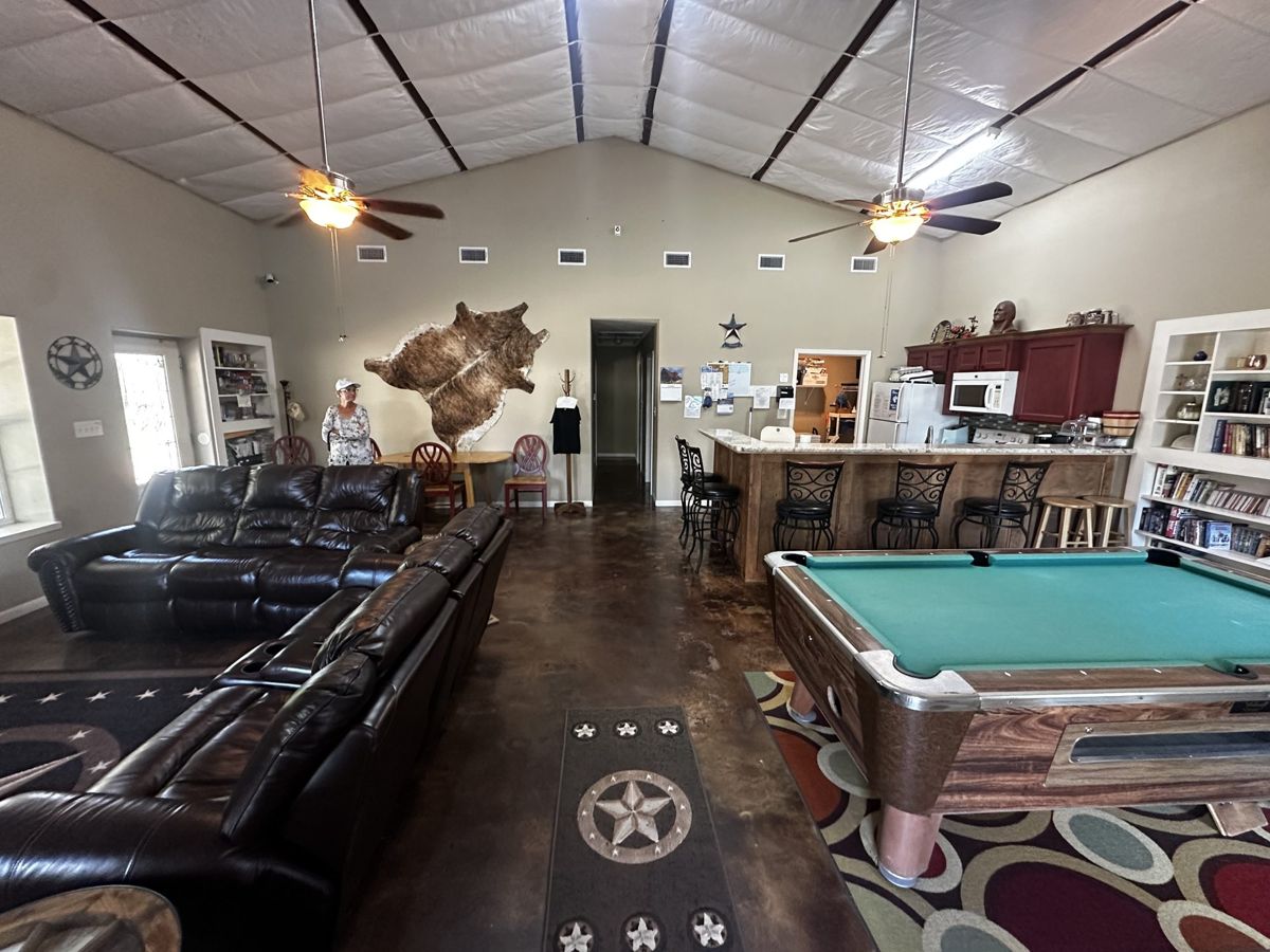 Clubhouse at Red Cloud RV Park with pool table, leather sofas and kitchen bar