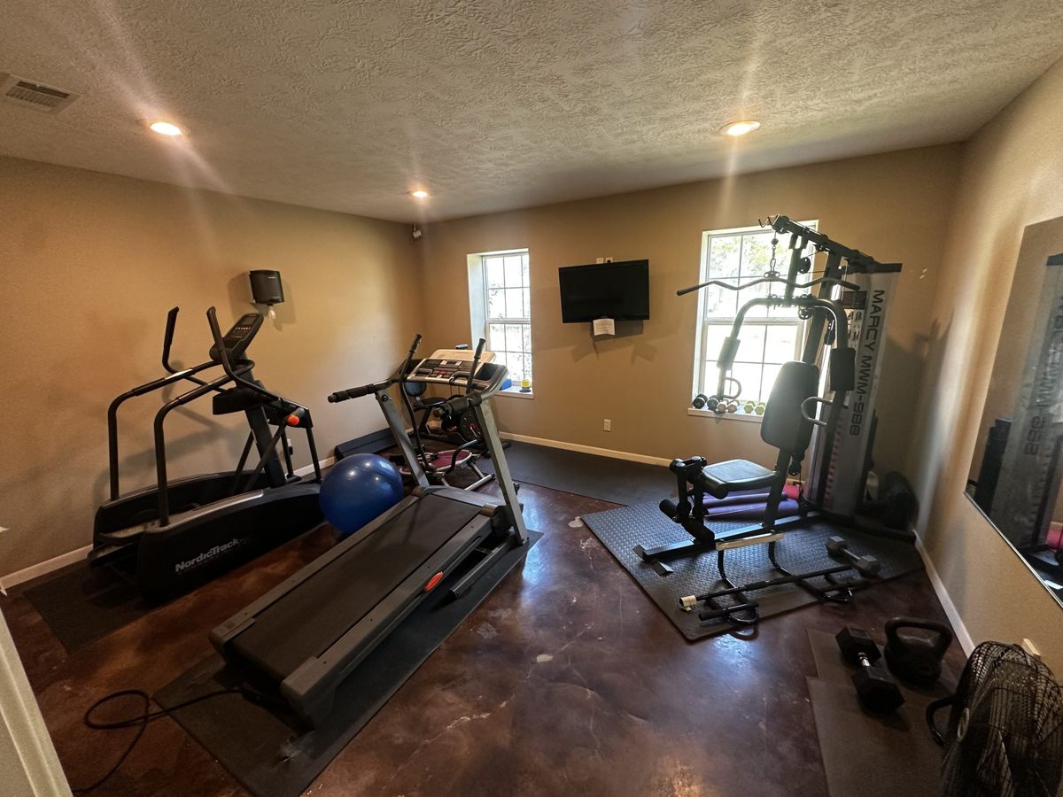 Fitness room with treadmill, elliptical and weight machine at Red Cloud RV Park